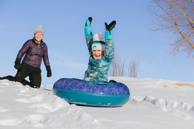 Families ice skating and snow tubing on Tributary property