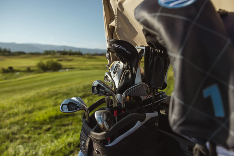 A Tributary caddie reading a putt with a member