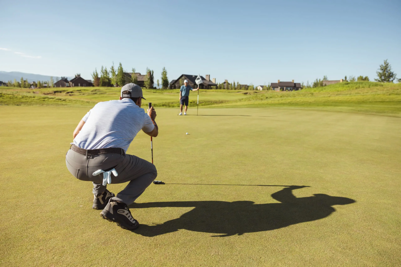 Golfers on the Tributary course with the Tetons in the distance