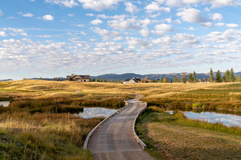 Hiker on a Tributary trail with the Tetons in view